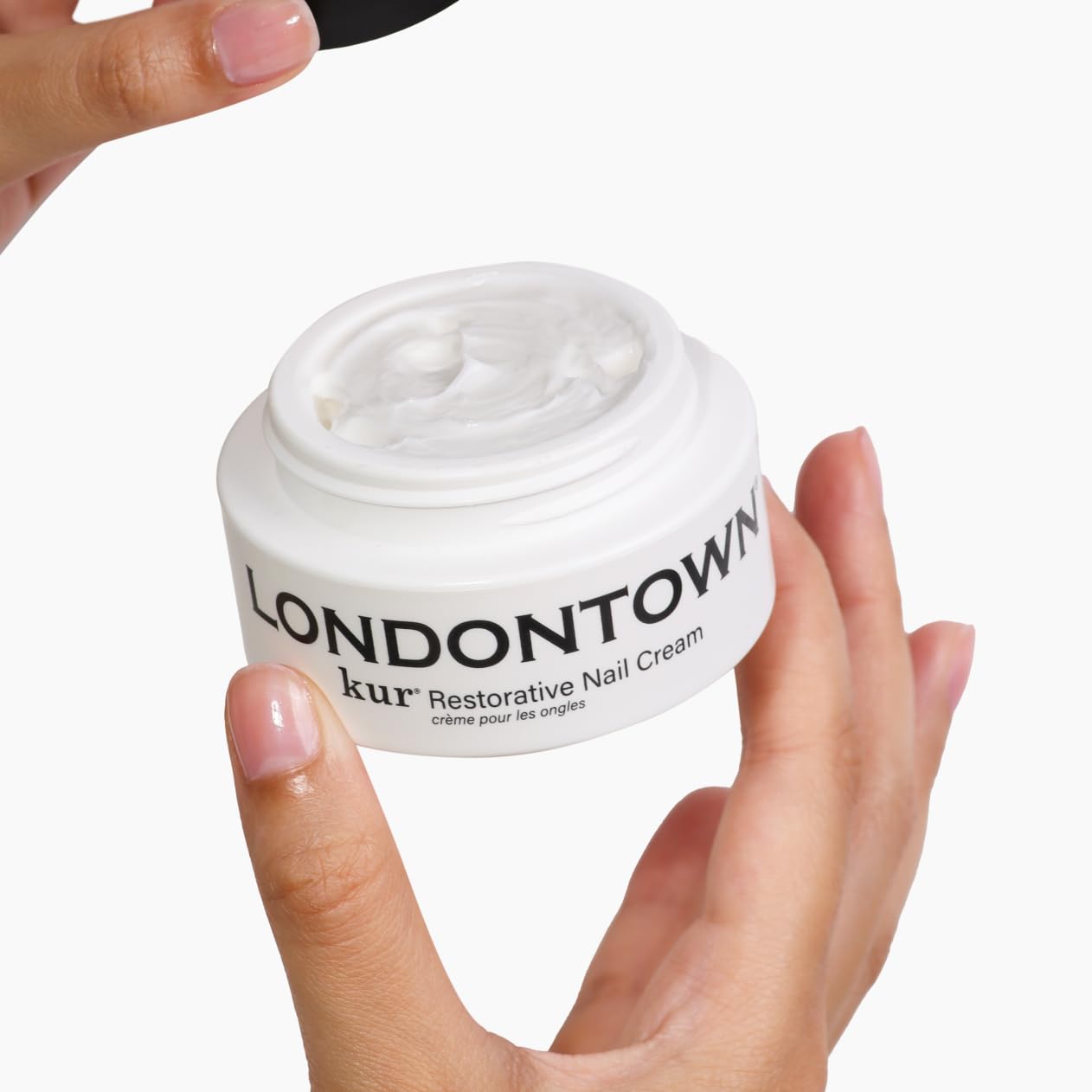 LONDONTOWN kur Restorative Nail Cream for nourishing and strengthening nails, shown in a sleek tube with a silver cap.