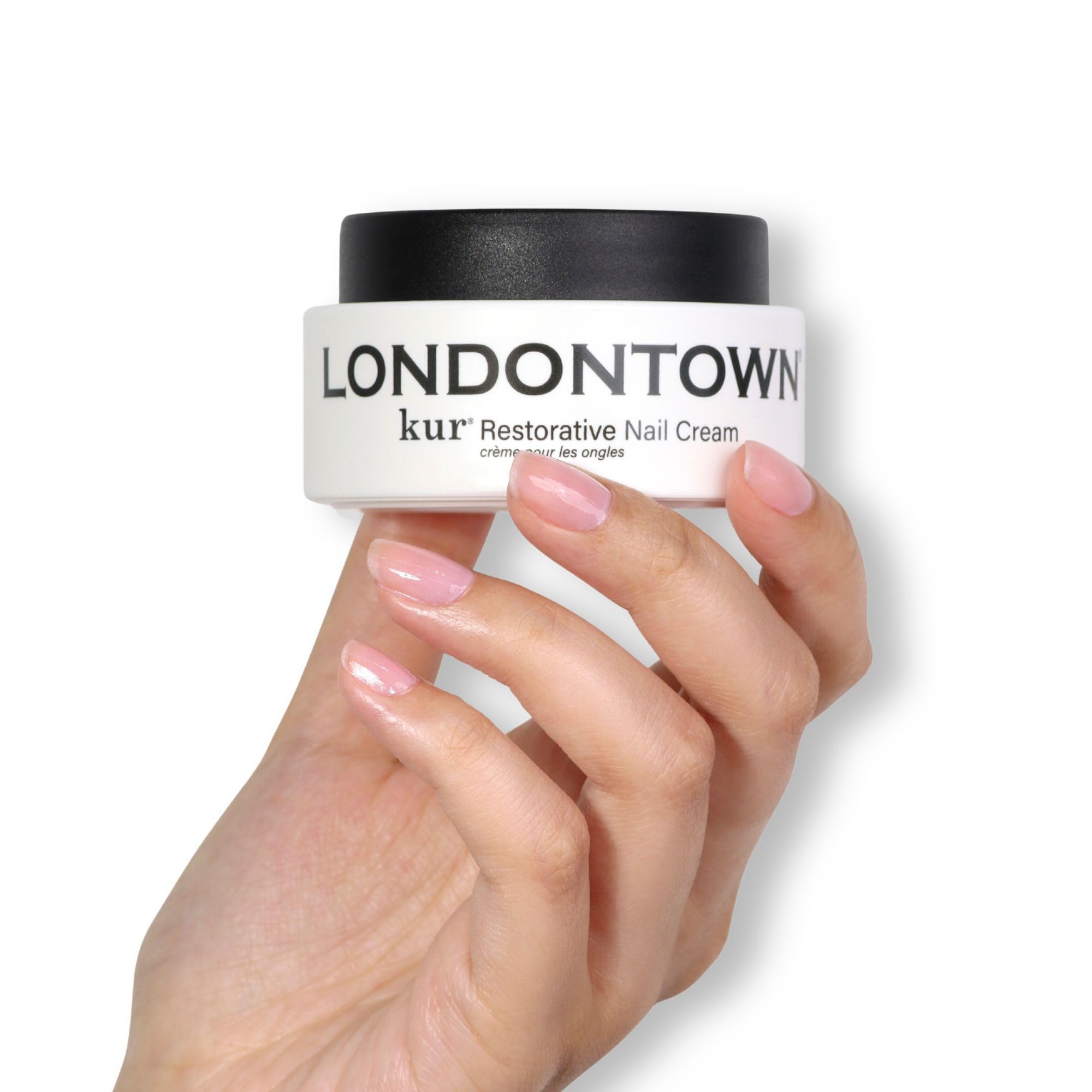 LONDONTOWN Kur Restorative Nail Cream applied to nails and cuticles, showcasing healthy, nourished nails and smooth skin.