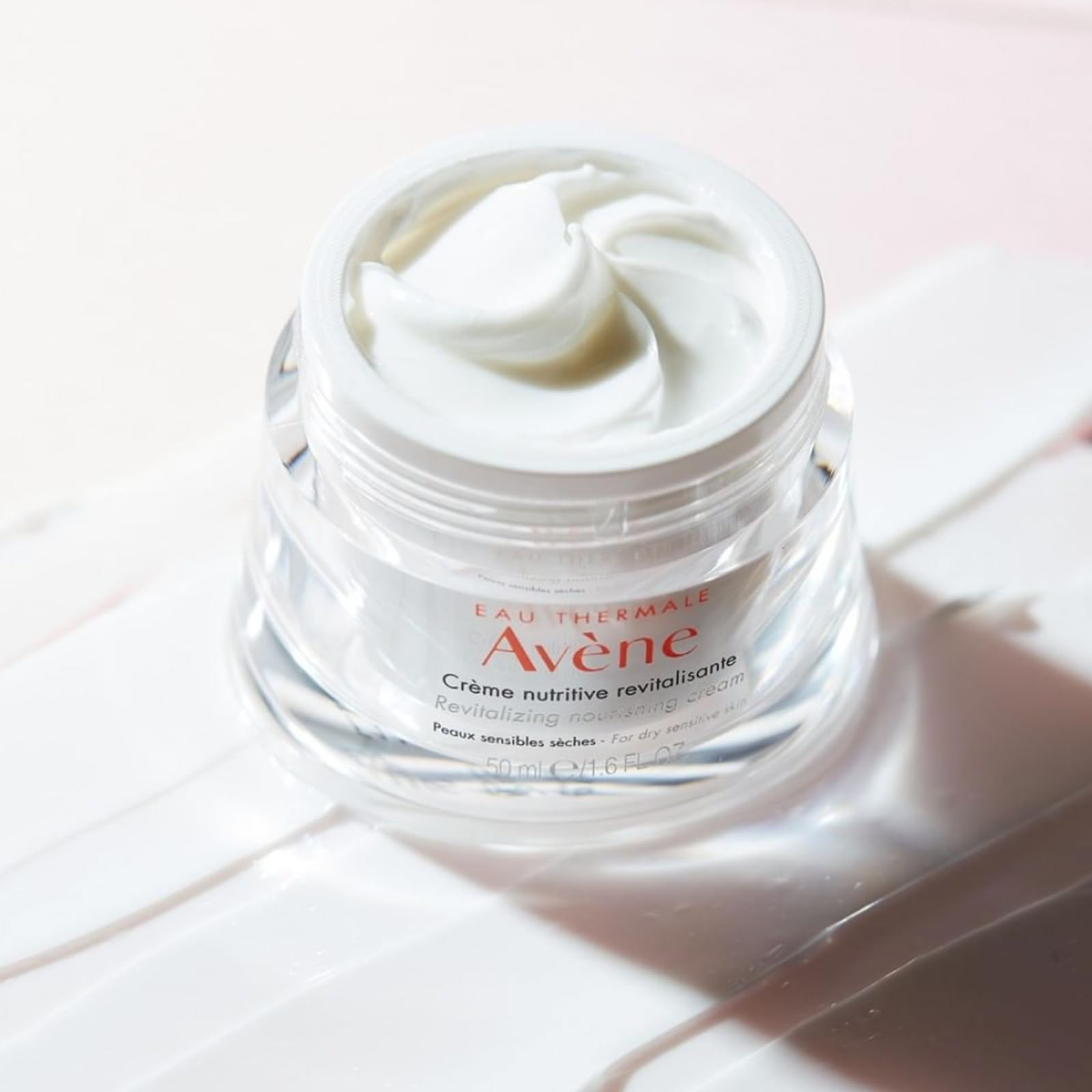 Eau Thermale Avène Revitalizing Nourishing Cream for dry skin in a 1.6 oz jar, smooth and creamy moisturizer with a gentle texture.