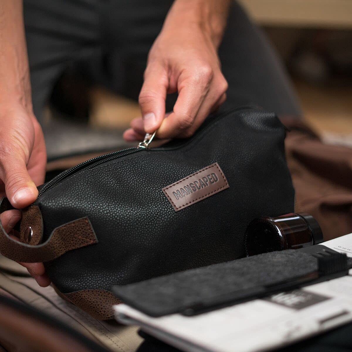 MANSCAPED® The Shed men's toiletry bag, PU leather Dopp kit, compact cosmetic case with zipper and handle for travel storage.