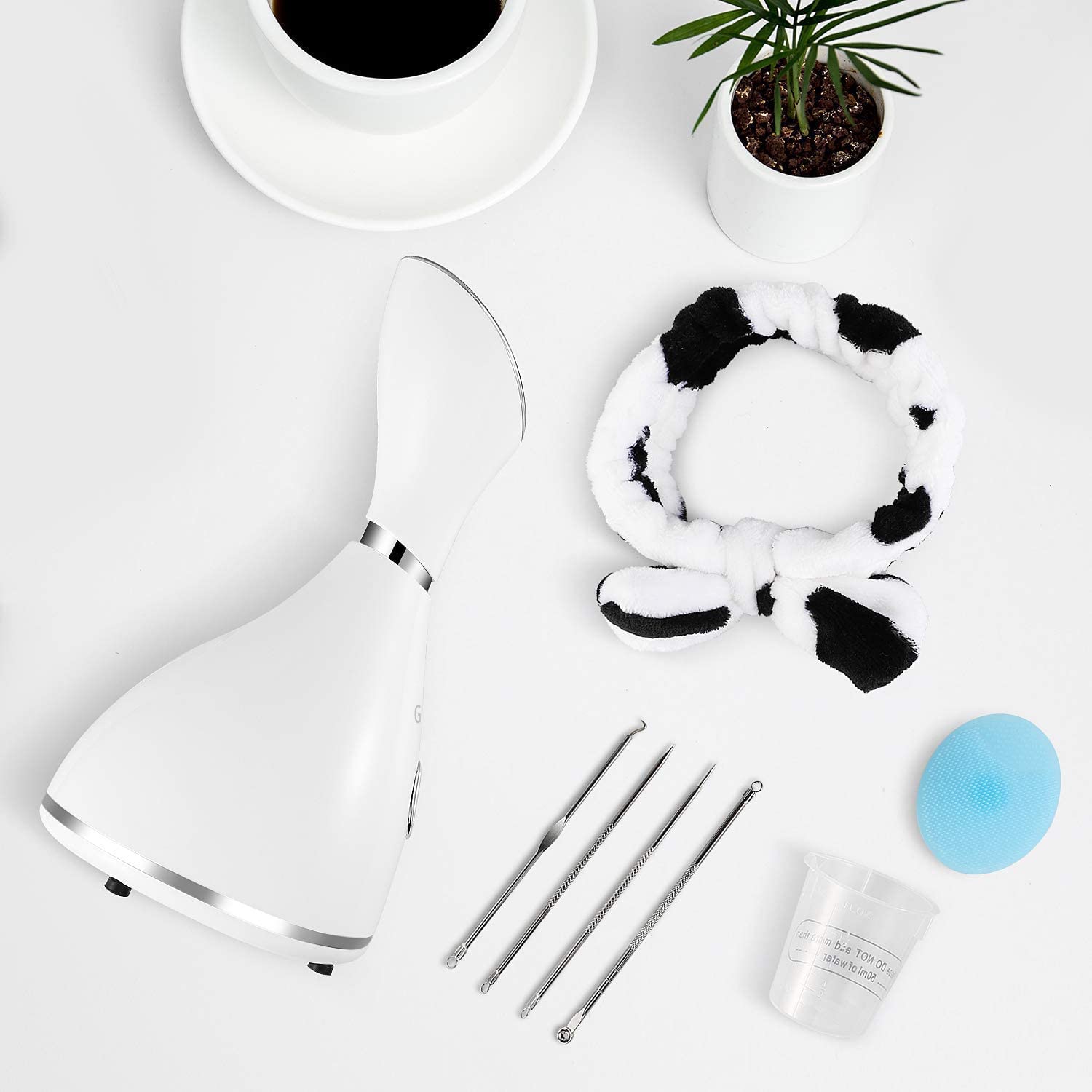 Surwit GETANYE Nano Ionic Facial Steamer with blackhead remover kit, facial brush, and hair band, emitting gentle steam for skin hydration.
