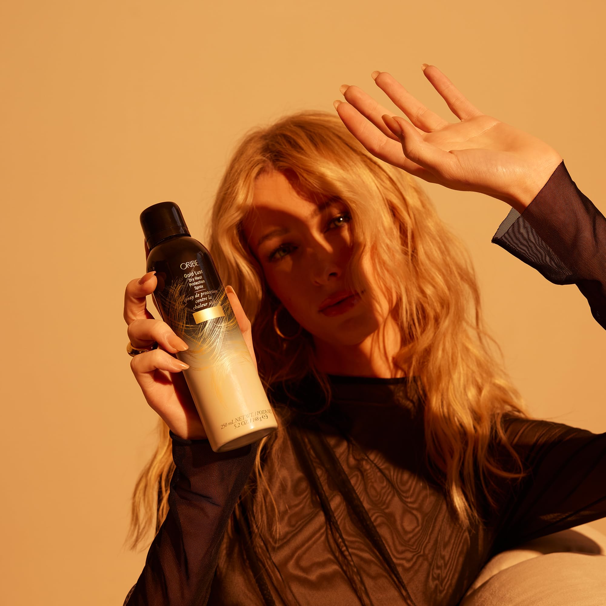 Oribe Gold Lust Heat Protection Spray for hair, 5.2oz, protects against heat up to 450°F, ideal for styling with heat tools.