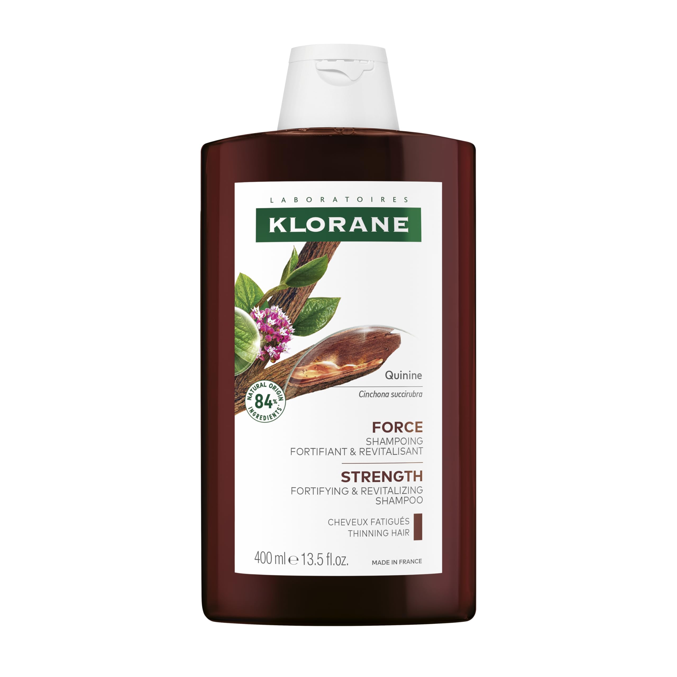 Klorane Quinine Thickening Shampoo for hair loss, 13.5 oz, in a clear bottle with purple label, showing shampoo lathering on hair