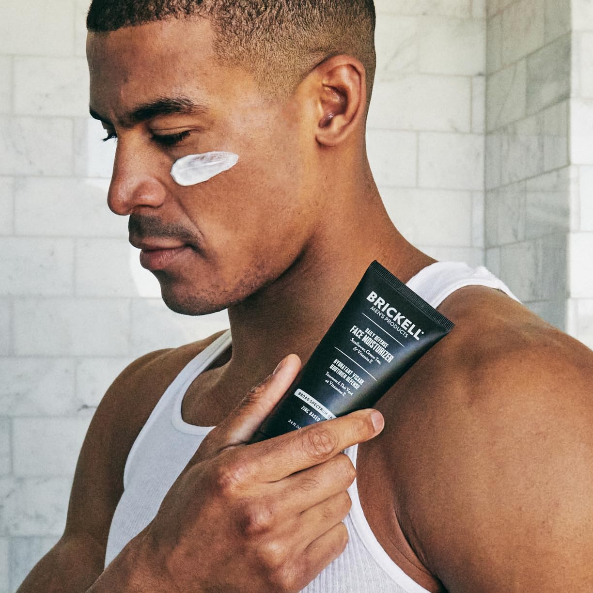 Brickell Men's Daily Defense SPF20 face moisturizer with zinc, green tea, and vitamin E, in 3.4oz unscented sunscreen tube.