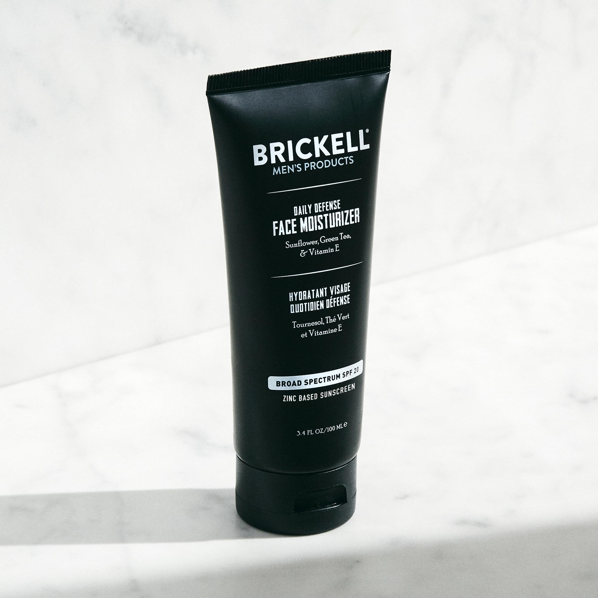 Brickell Men's Daily Defense SPF20 face moisturizer with zinc, green tea, and vitamin E, in a 3.4oz unscented sunscreen tube.