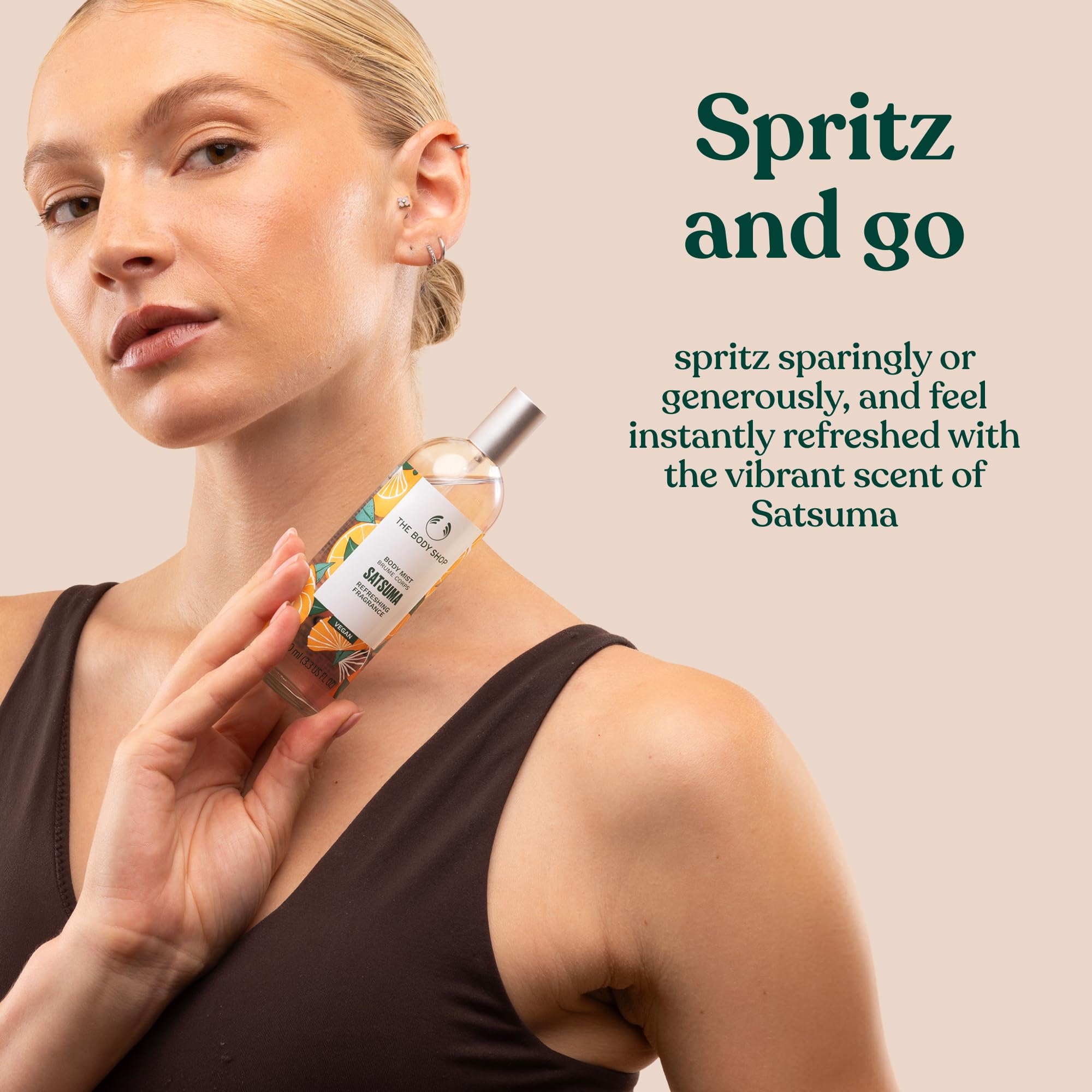 The Body Shop Satsuma Body Mist, vegan citrus spray, 3.3 oz, with bright orange and yellow packaging, showcasing the refreshing fragrance.