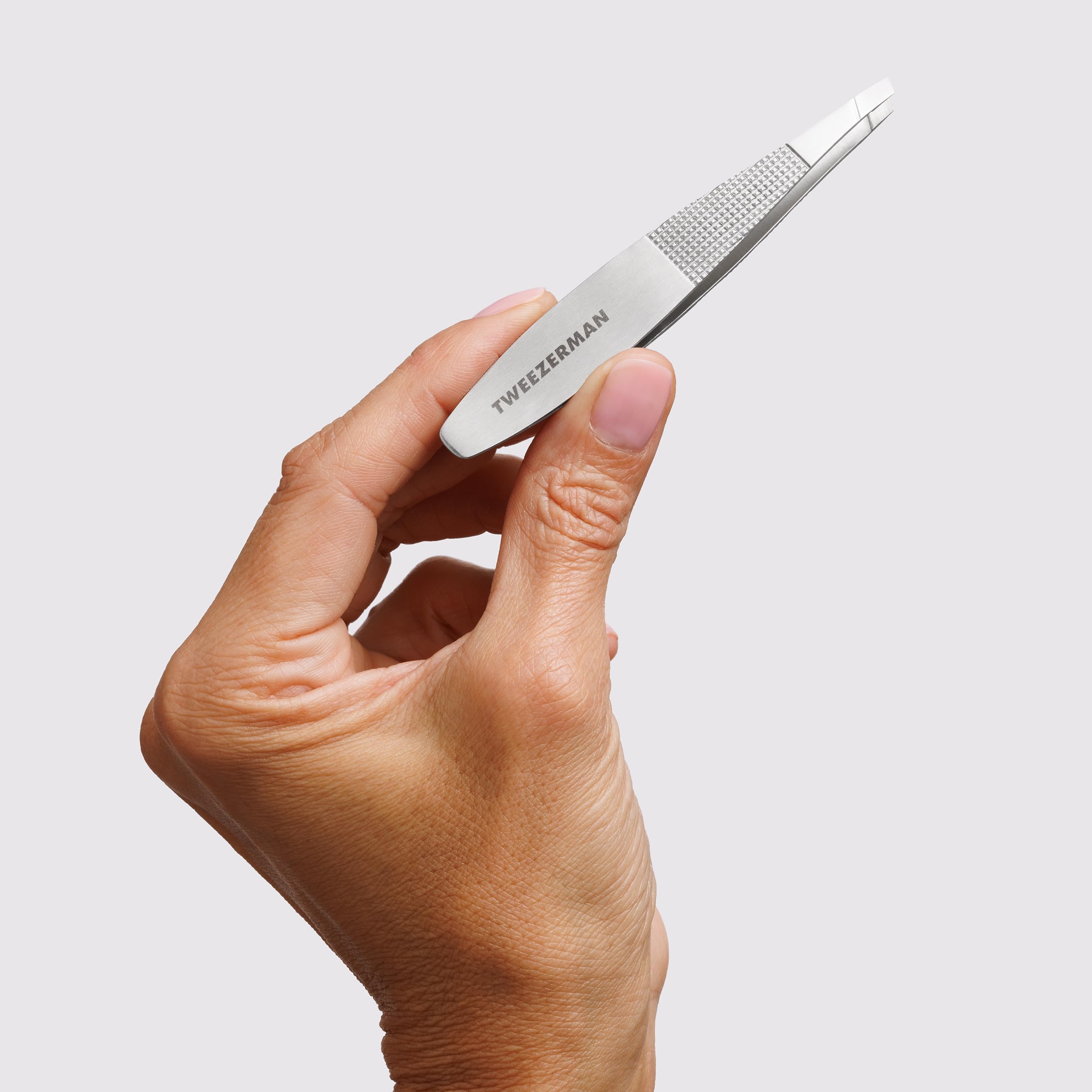 Tweezerman wide grip slant tweezer made of stainless steel, featuring precision slanted tips for accurate hair removal.