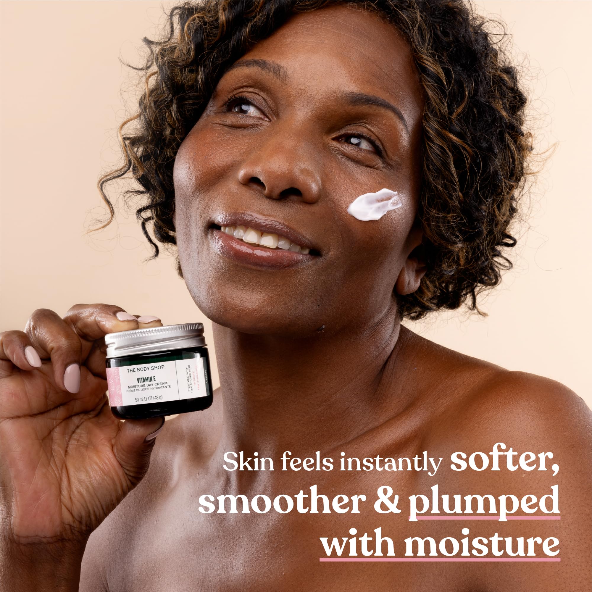 The Body Shop Vitamin E Moisture Cream in 3.4oz jar, showing the skincare moisturizer with a smooth, creamy texture.