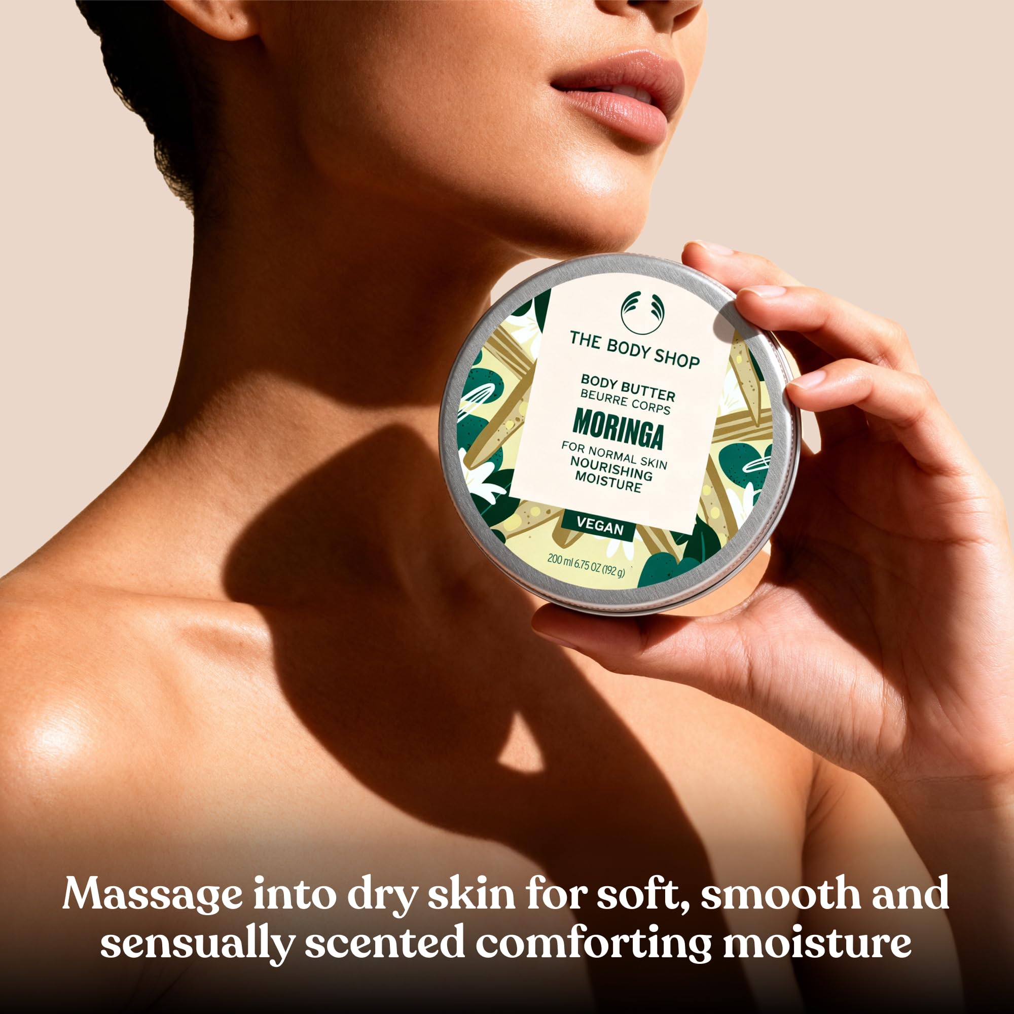 The Body Shop Moringa Body Butter in a 6.75 oz jar, featuring creamy moisturizer with floral Moringa scent and smooth texture.