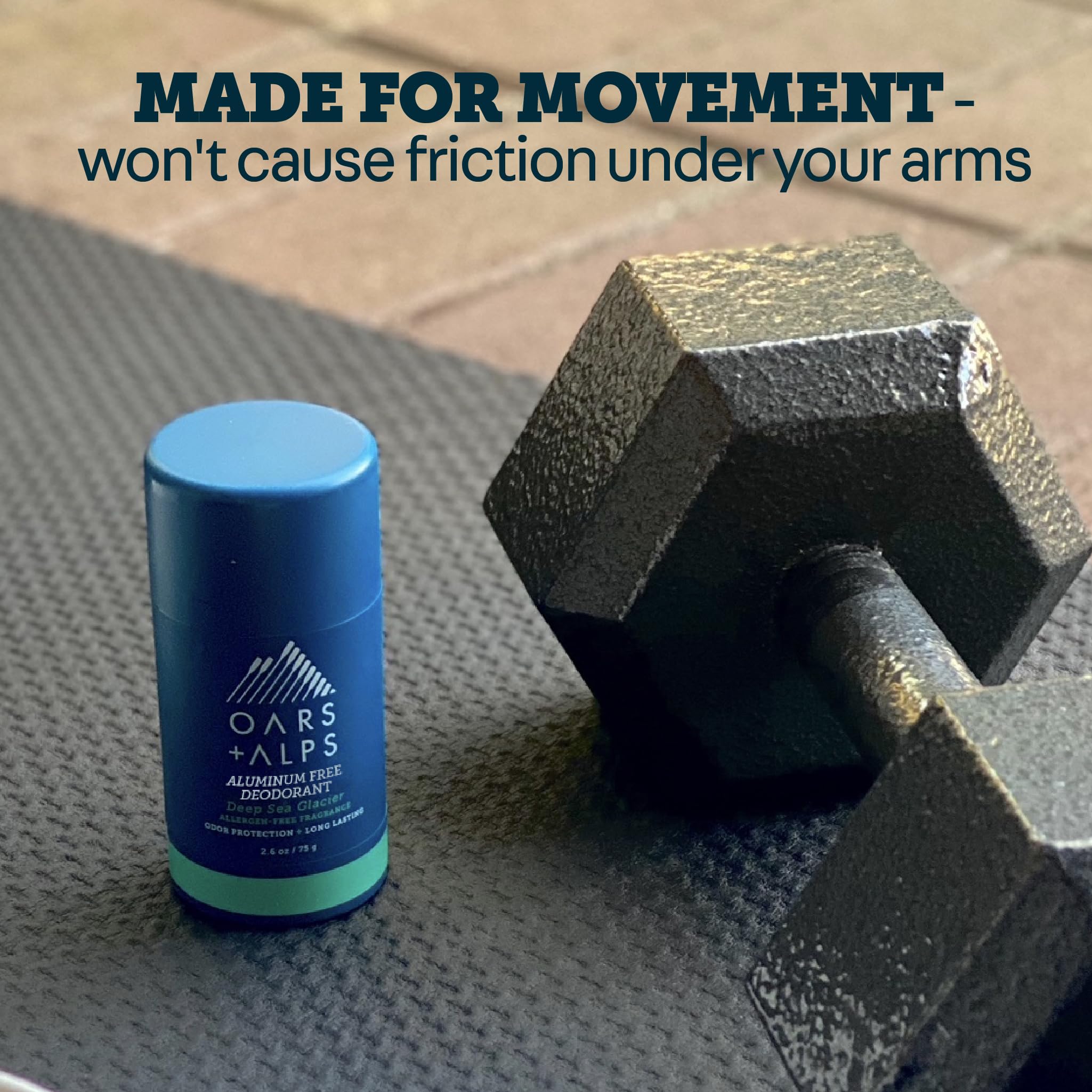 Oars + Alps aluminum-free men's deodorant clear stick, 2.6oz, showing the deodorant stick and packaging in a natural setting