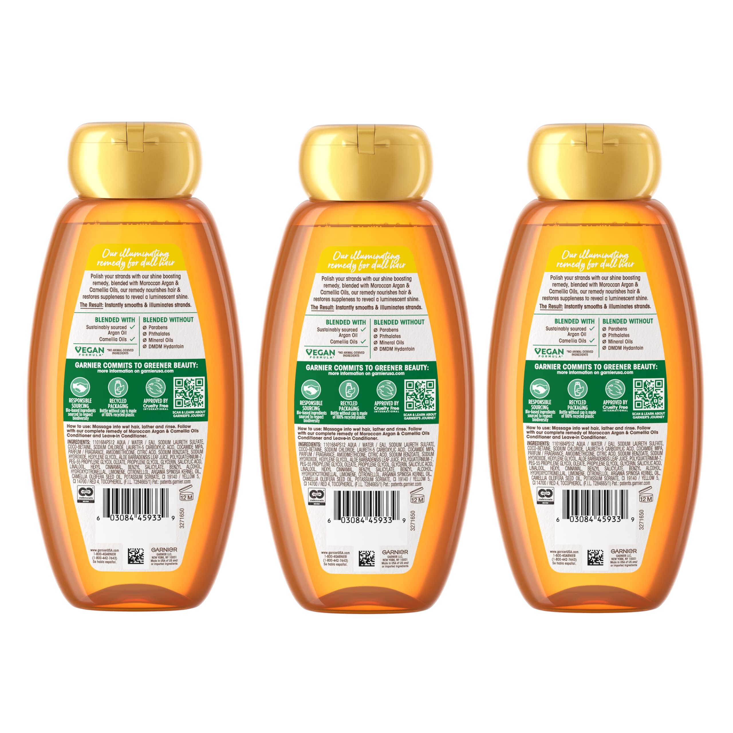 Garnier Whole Blends Argan & Camellia Shampoo 3-pack bottles with labels showing natural ingredients and hair care benefits.