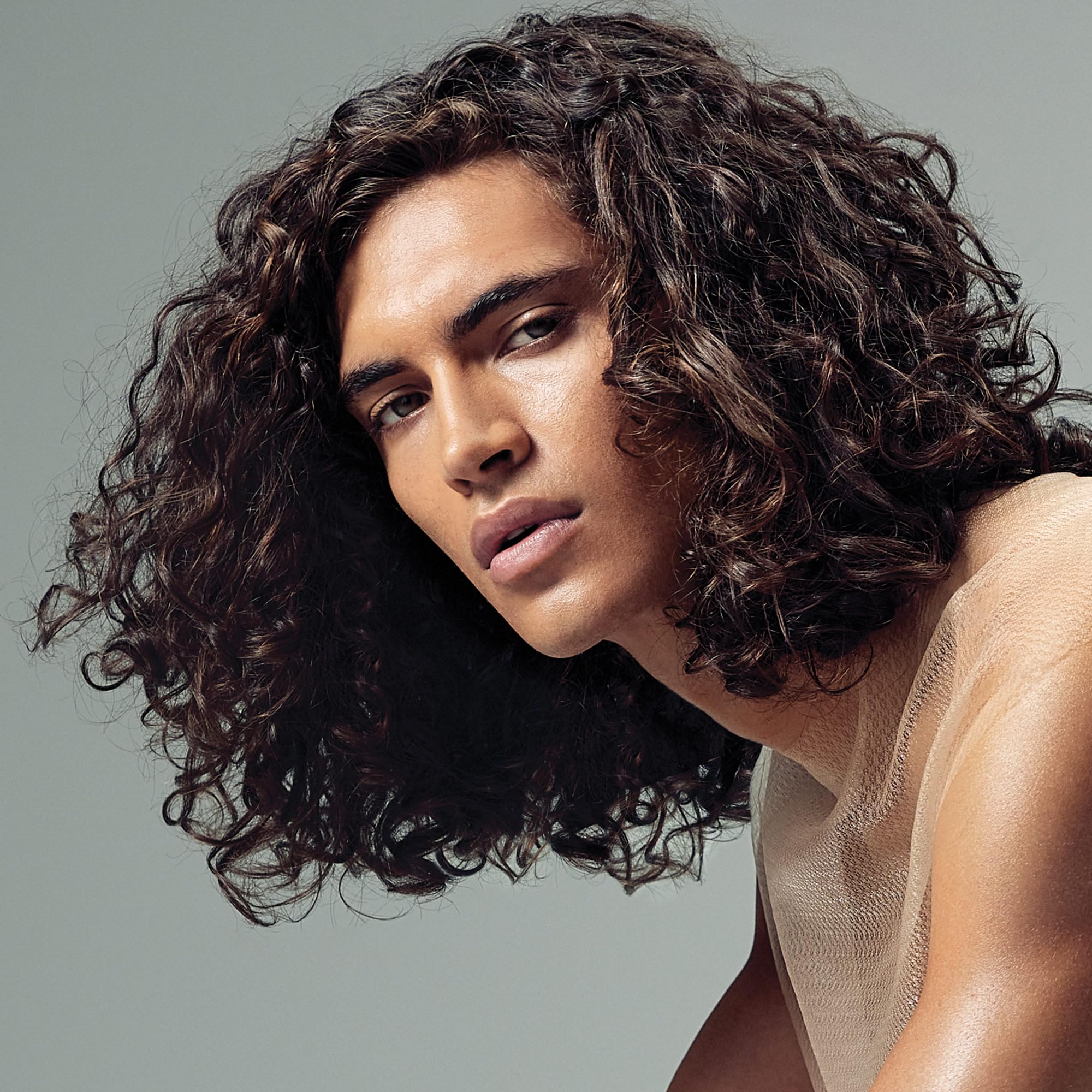 Paul Mitchell Spring Loaded Frizz-Fighting Shampoo 8.5 oz bottle with pump dispenser, designed to smooth frizzy hair and add shine.