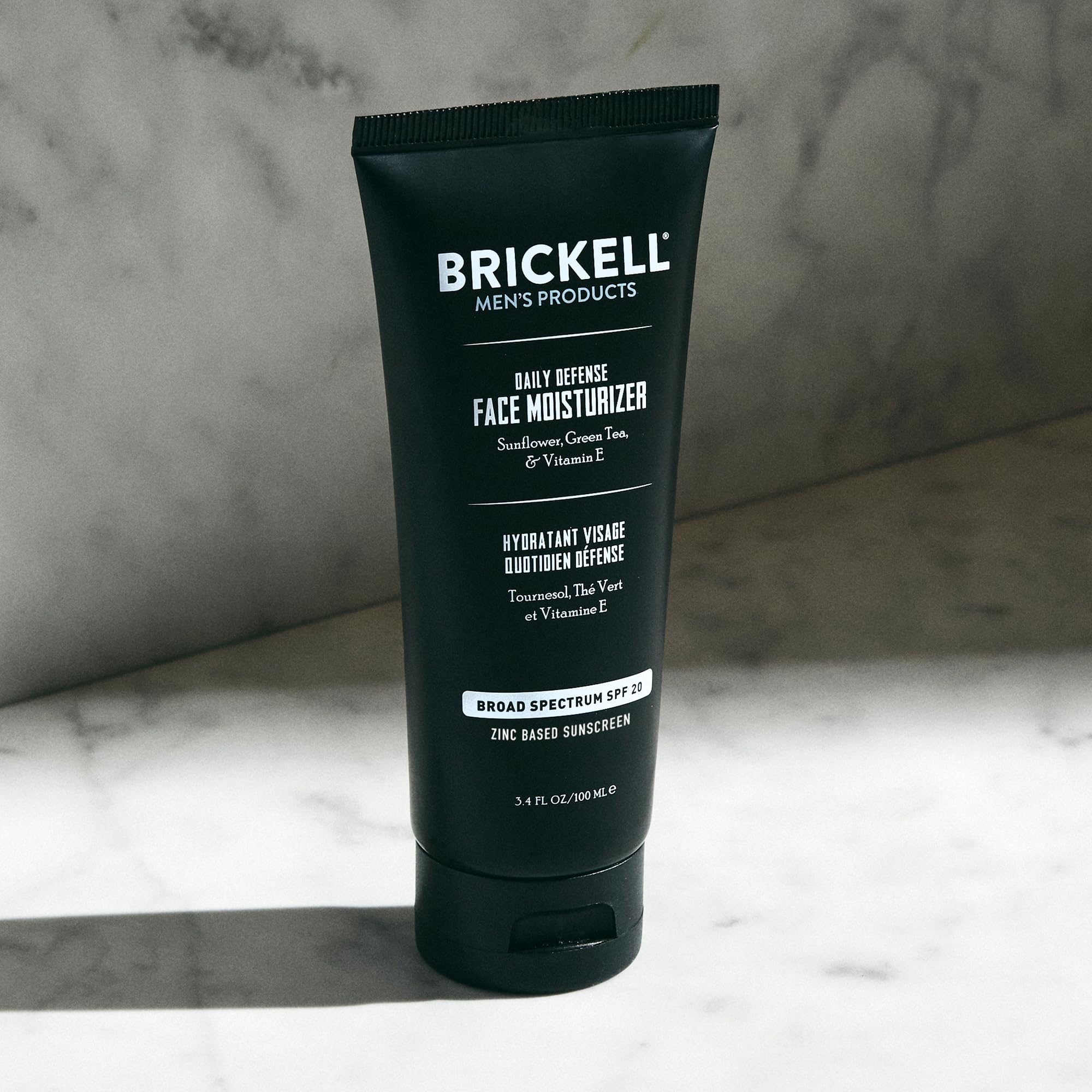 Brickell Men's Daily Defense SPF20 face moisturizer with zinc, green tea, and vitamin E, providing hydration and UVA/UVB protection.