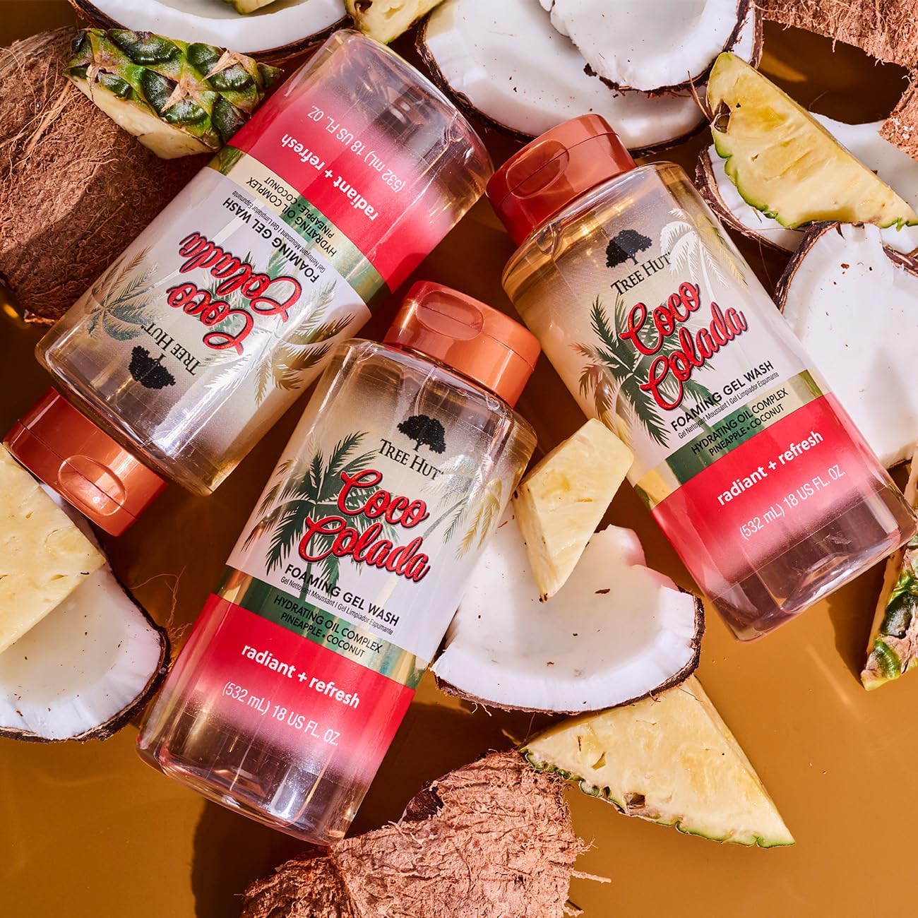 Tree Hut Coco Colada foaming body wash in 18 fl oz bottle, featuring tropical coconut scent and creamy lather for skin cleansing.
