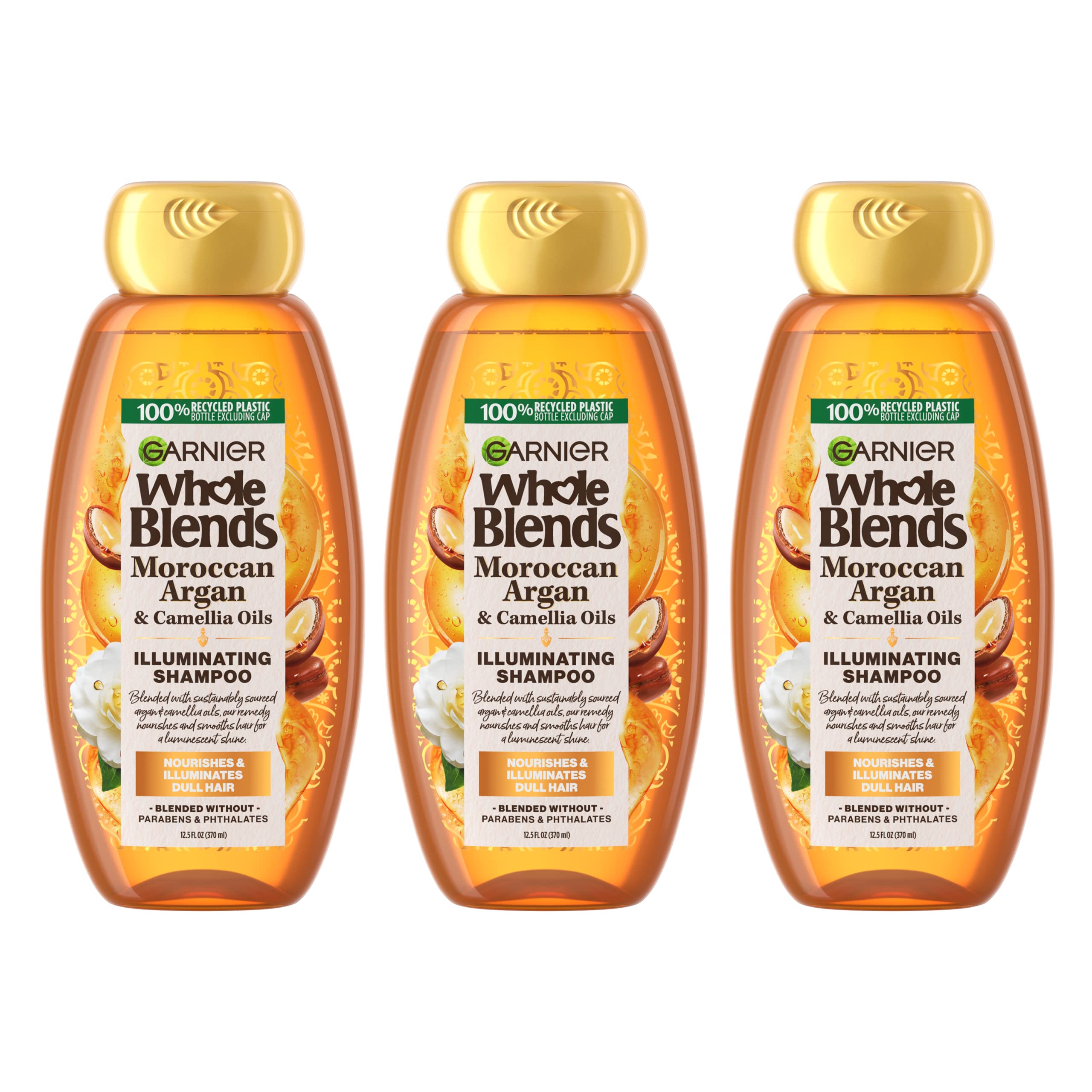 Garnier Whole Blends Argan and Camellia Shampoo 3-pack bottles with labels, positioned on a plain background.