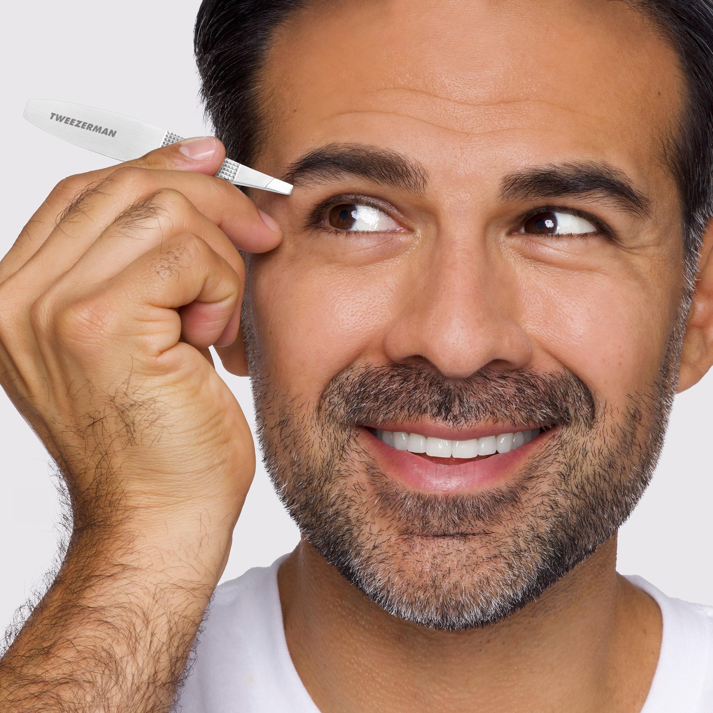 Tweezerman Wide Grip Slant Tweezer in stainless steel with ergonomic design for precise eyebrow grooming and hair removal.