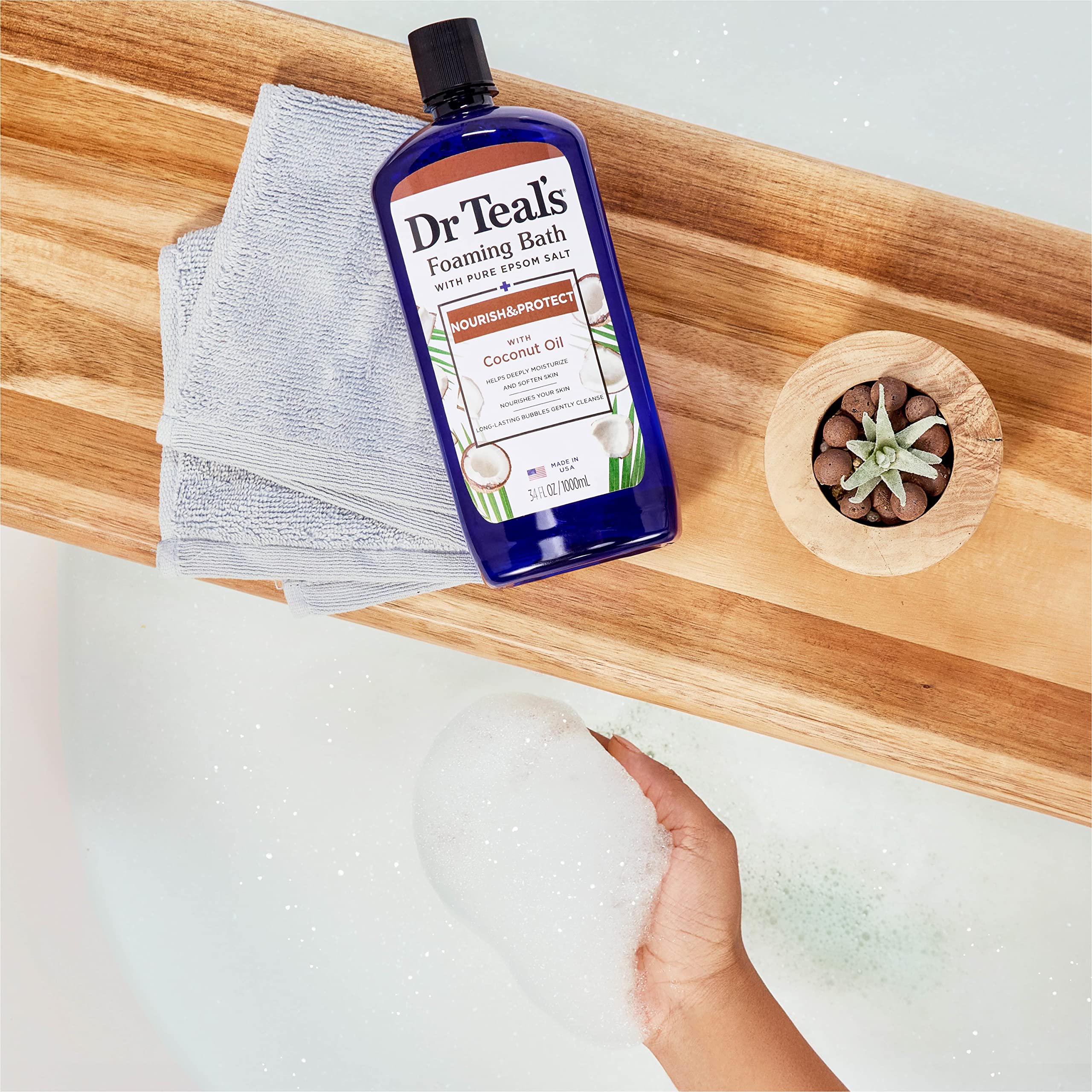 Dr Teal's foaming bath additive with Epsom salt and coconut oil, 34 fl oz bottles in a pack of four, showcasing the product bottles.