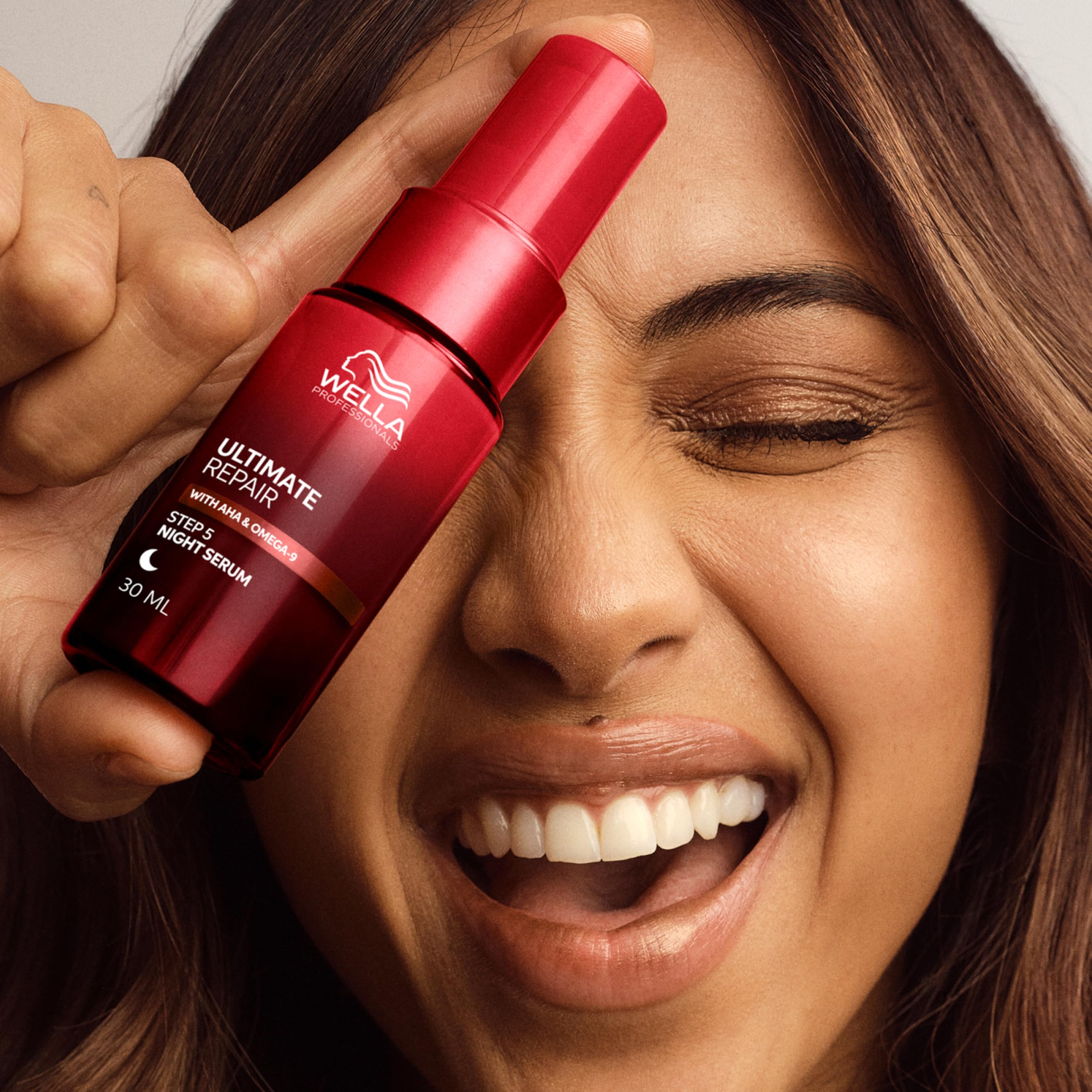 Wella Professionals Ultimate Repair Night Serum for hair, showing the serum bottle with a sleek design and label.