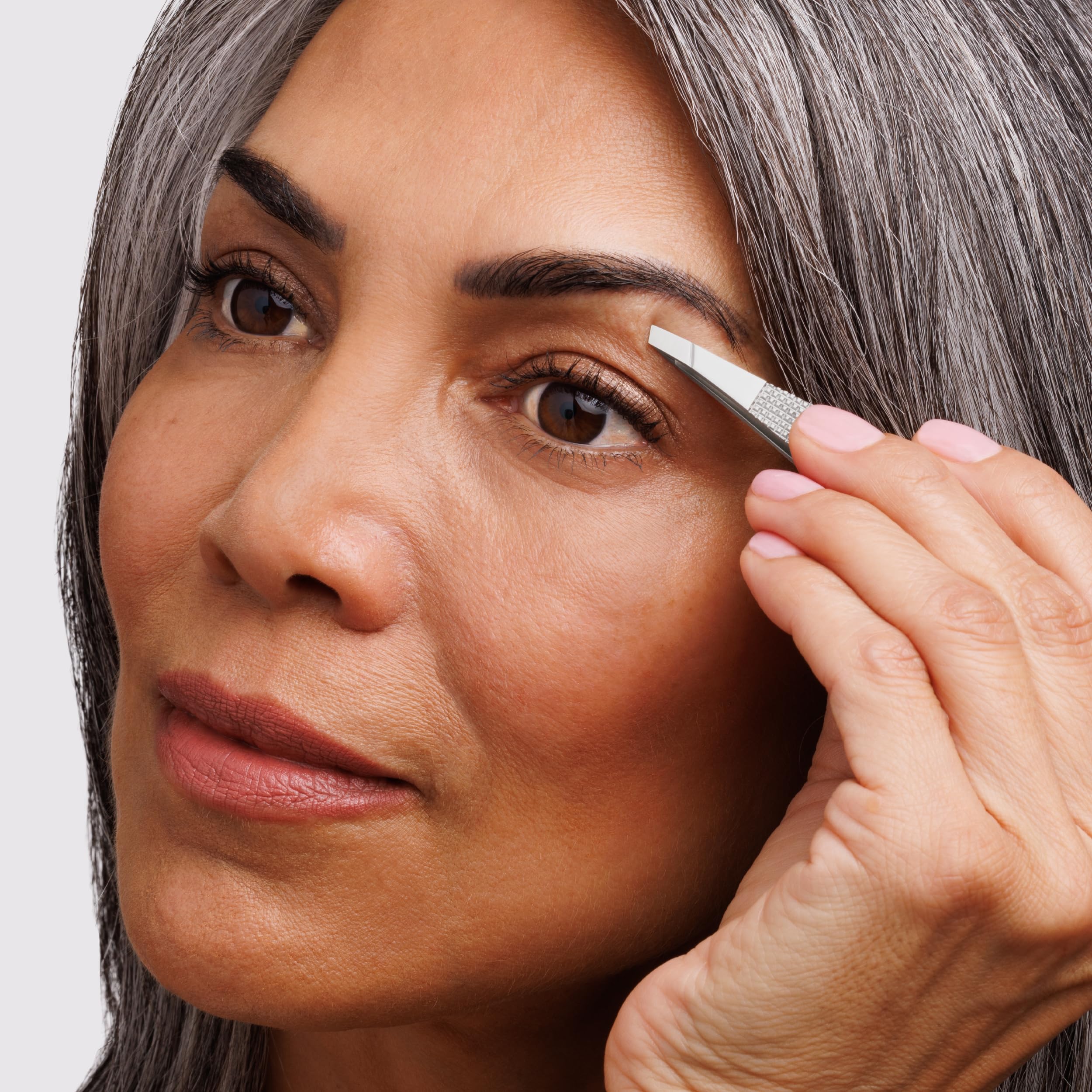 Tweezerman Wide Grip Slant Tweezer in stainless steel with ergonomic design for precise eyebrow grooming.