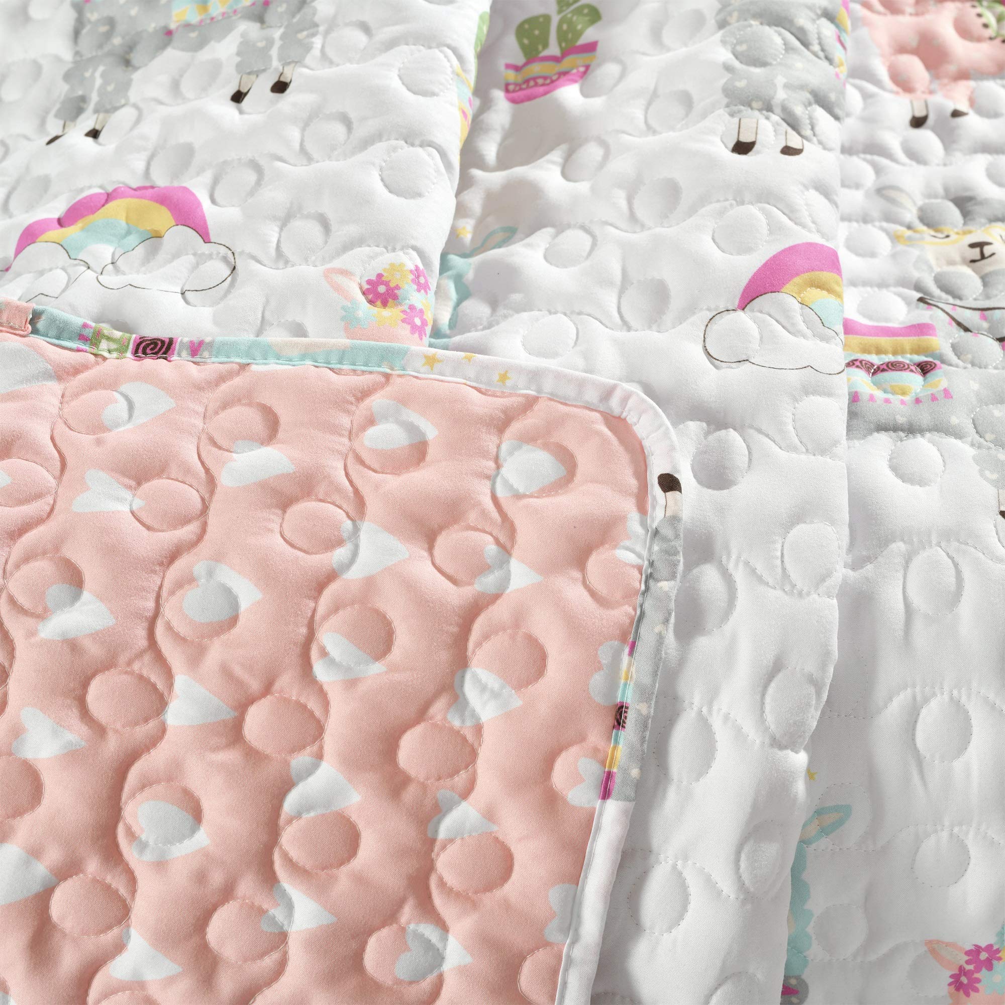 Lush Decor Southwest Llama Cactus throw blanket for kids, white and blush, reversible boho quilted toddler blanket in a kids' room.