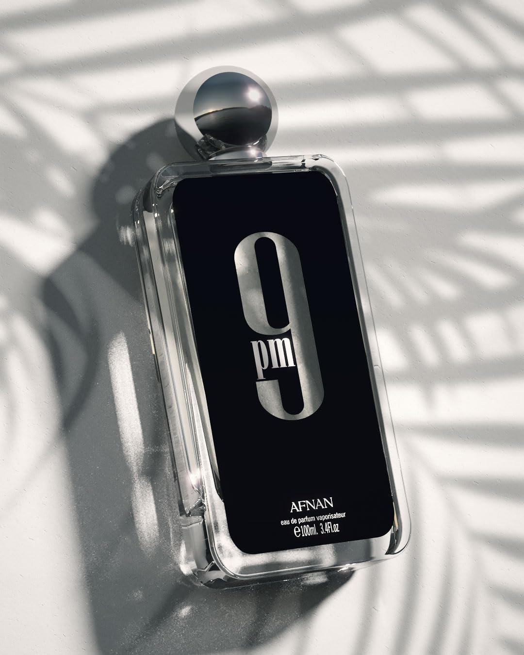 Afnan 9 PM for Men Eau De Parfum 3.4 Fl Oz bottle, stylish personal fragrance with sleek design and branding visible.