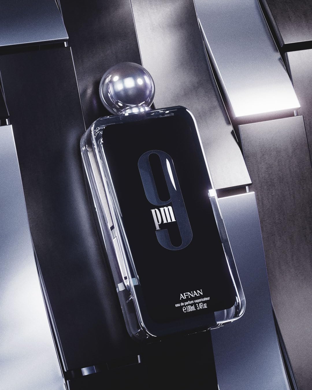 Afnan 9 PM for Men Eau De Parfum bottle, 3.4 Fl Oz, with sleek packaging and dark fragrance liquid visible.