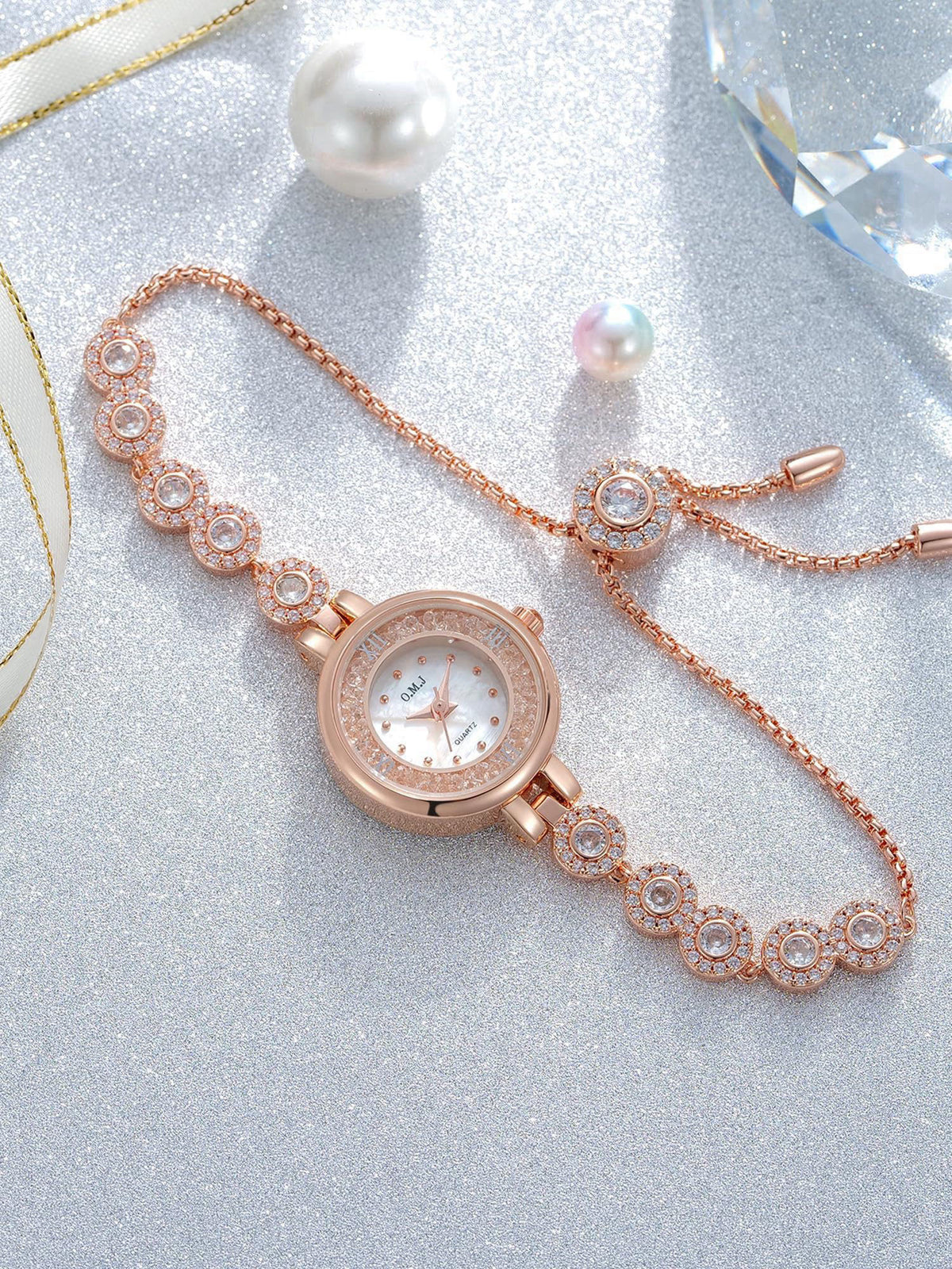 O.M.J Womens Watch Rose Gold Mother of Pearl Dial Birthstone Crystal Accents Ladies Bracelet – back view and specificati