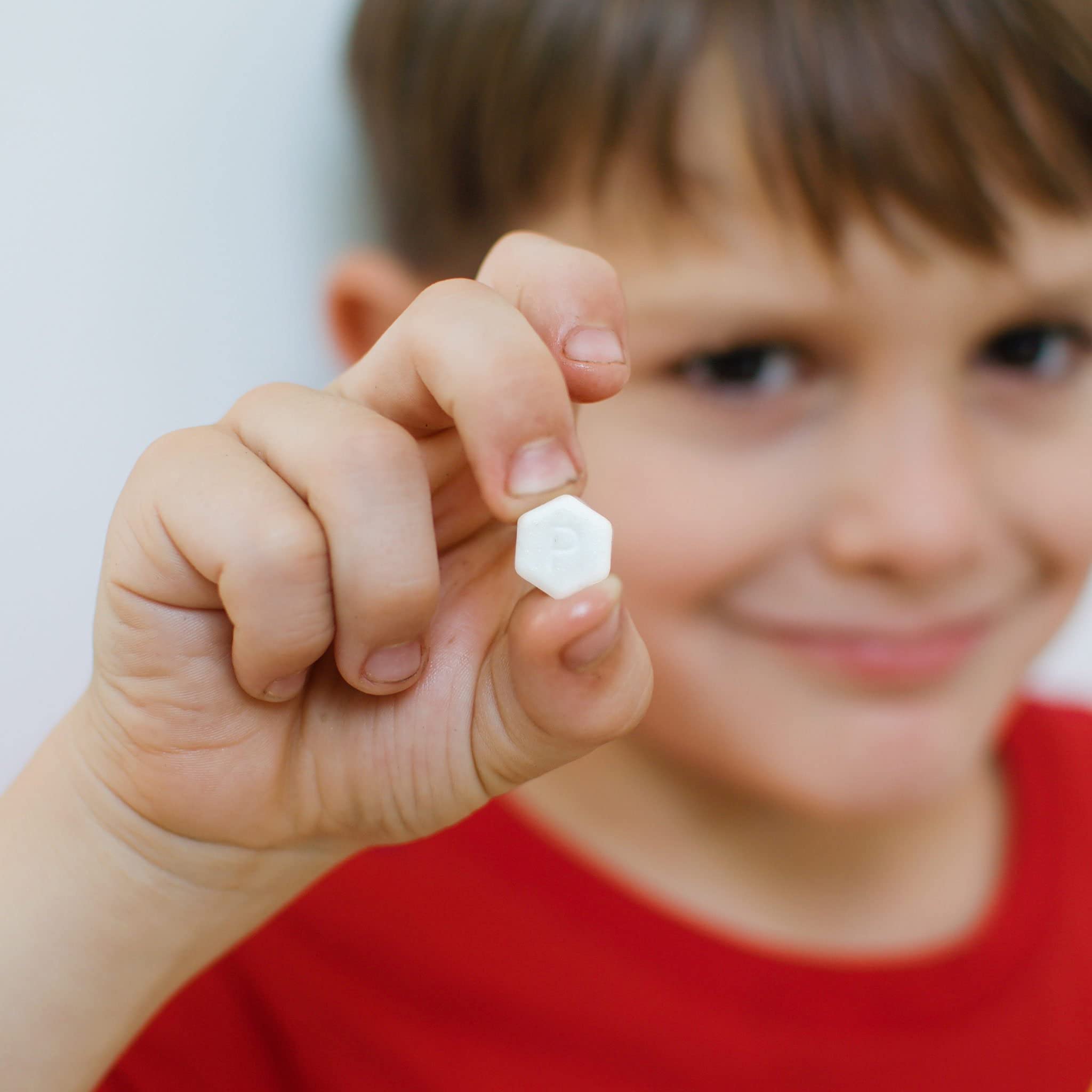 SuperBee Dentos fluoride-free toothpaste tablets in a clear container, showing 100 small round tablets for oral hygiene.